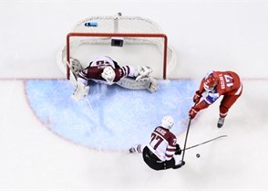 GRAND FORKS, NORTH DAKOTA - APRIL 18: Latvia's Roberts Kalkis #27 and Russia's Ivan Kozlov #17 
battle for the puck while Latvia's Gustavs Grigals #29 looks on during preliminary round action at the 2016 IIHF Ice Hockey U18 World Championship. (Photo by Matt Zambonin/HHOF-IIHF Images)

