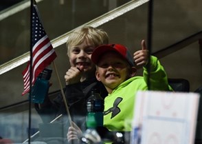 GRAND FORKS, NORTH DAKOTA - APRIL 14: Two young USA fans getting ready to watch their team take on Russia during preliminary round action at the 2016 IIHF Ice Hockey U18 World Championship. (Photo by Minas Panagiotakis/HHOF-IIHF Images)

